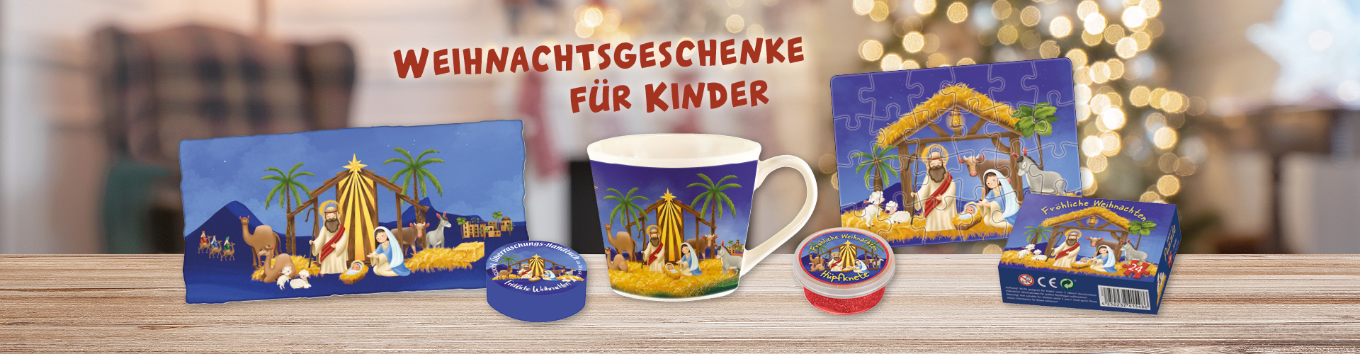 Weihnachtsgeschenke für Kinder: eine Tasse, ein Puzzle, Hüpfknete und ein Handtuch, vor einem unscharfen Hintergrund.