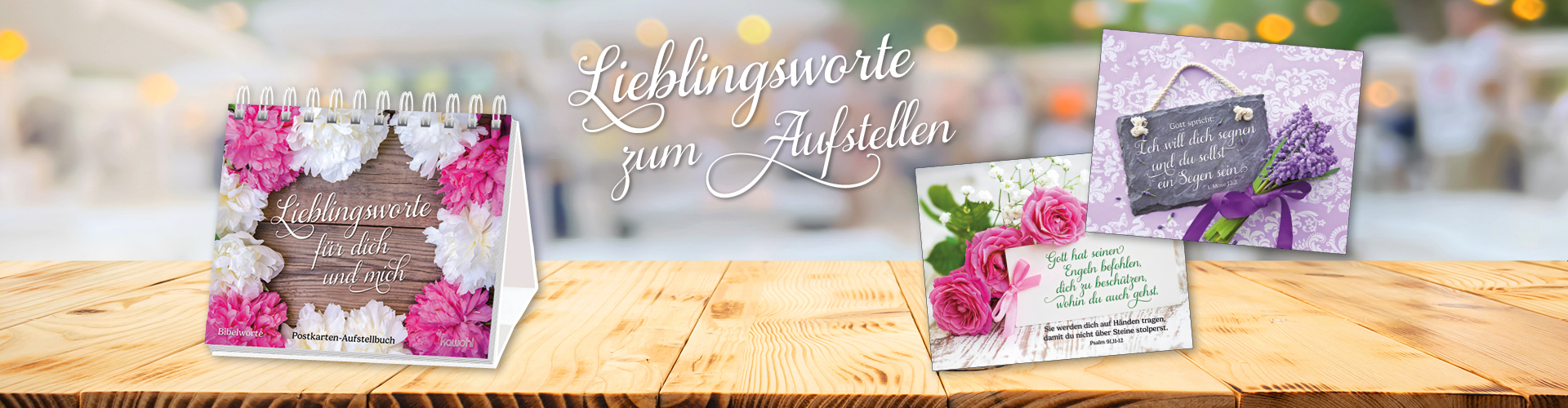 Dekoratives Aufstellbuch "Lieblingsworte für dich und mich" mit Blumenmuster, umgeben von Postkarten mit inspirierenden Sprüchen. Text: Lieblingsworte zum Aufstellen.